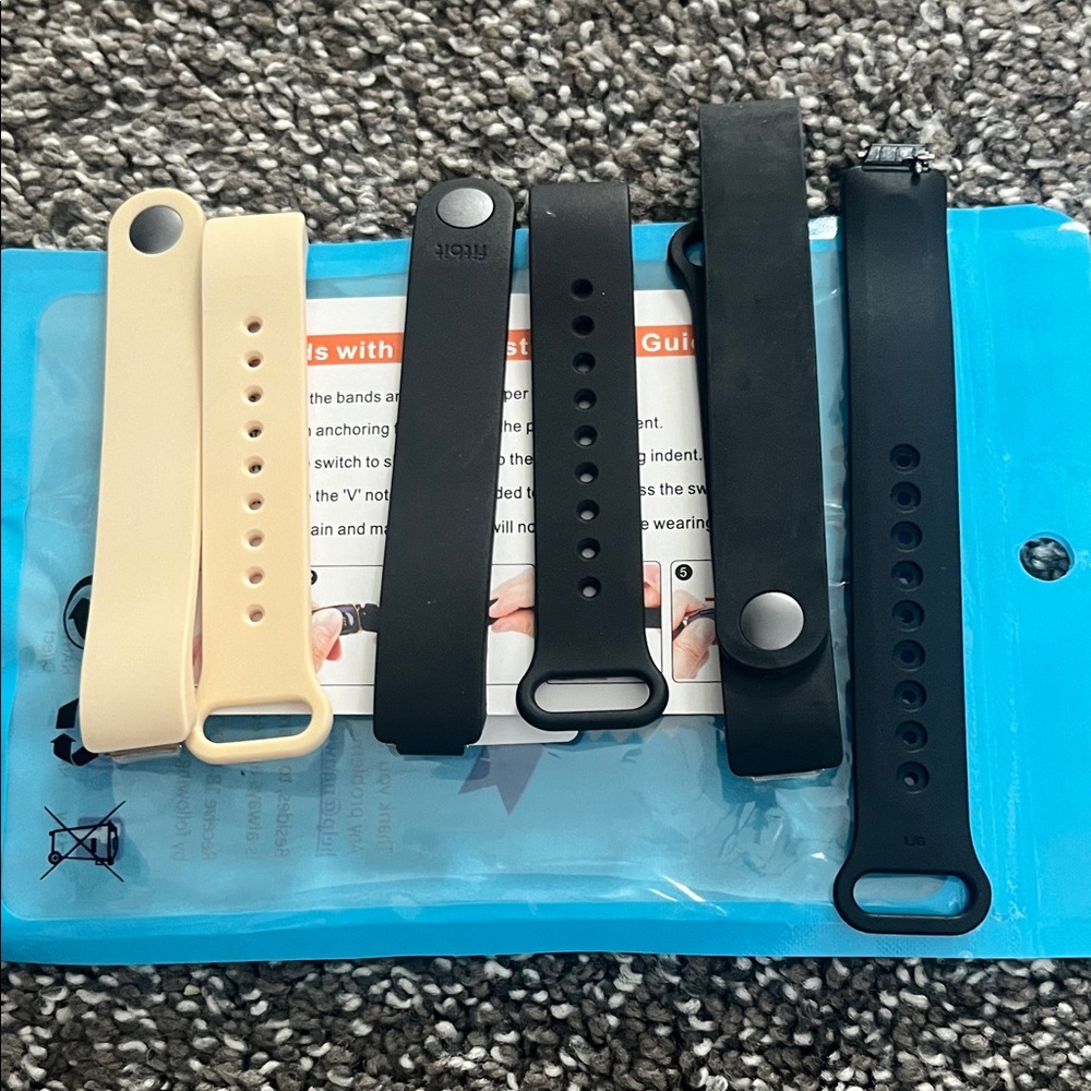 Fitbit Inspire bands and assembly kit. 2 black 1 nude band